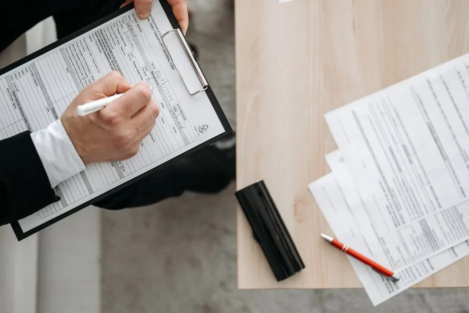 Person filling out a business documentation form