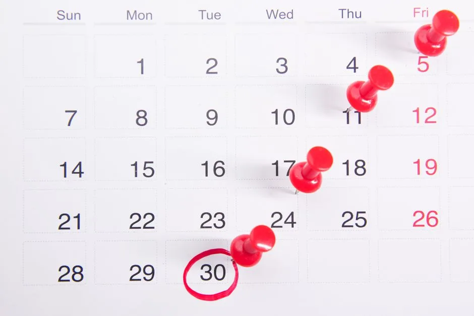 Wall calendar with a pinned reminder note