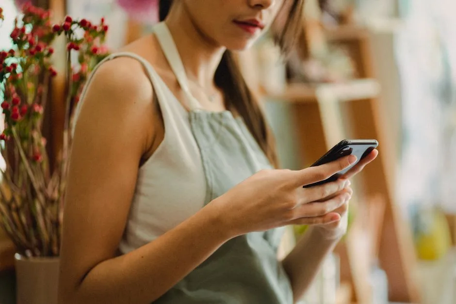 Small business owner checking a phone for missed calls