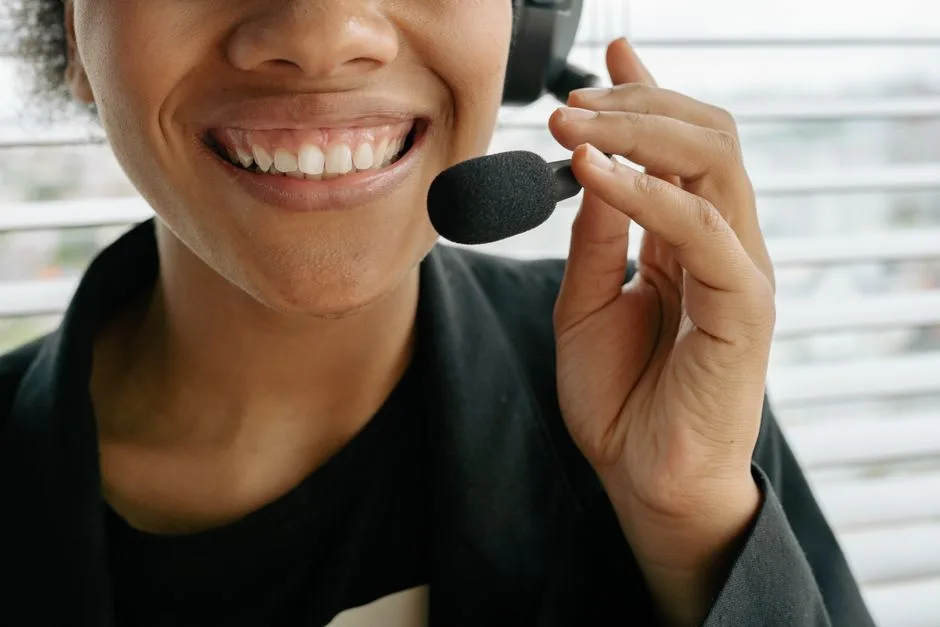 Customer service agent smiling while wearing a headset