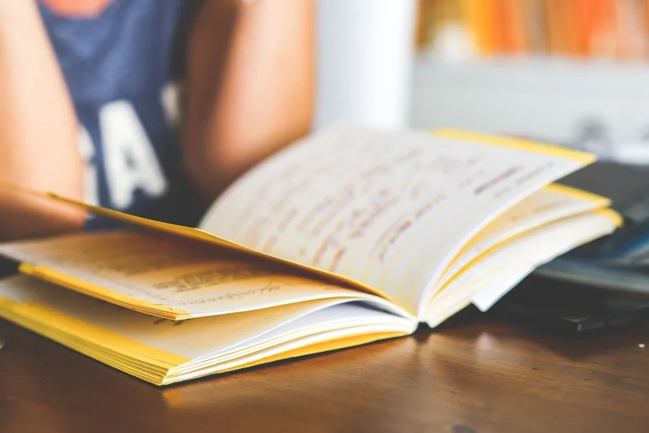 Person reading through a list of questions in a notebook