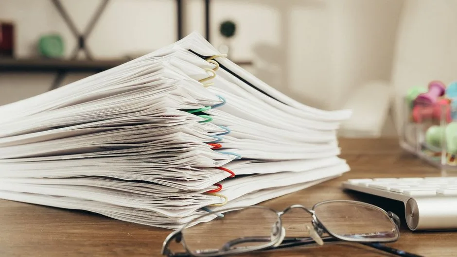 A thick stack of paper documents