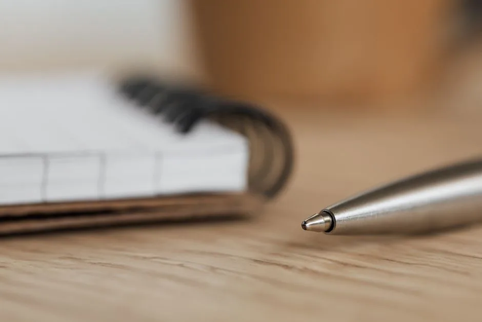 Close-up of an open notebook and pen