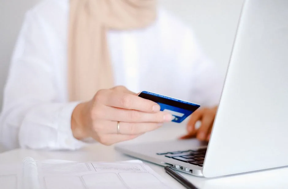 Person completing an online purchase on a laptop