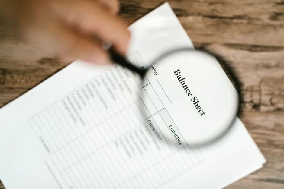 Magnifying glass over a document, searching for details