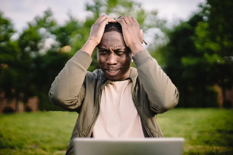 Frustrated person looking at a laptop screen